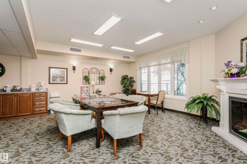 207 9820 165 Street, Edmonton, AB - Indoor Photo Showing Dining Room With Fireplace