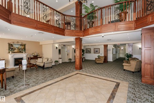 207 9820 165 Street, Edmonton, AB - Indoor Photo Showing Other Room With Fireplace