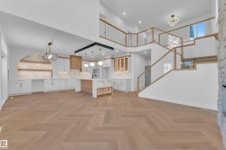 Unfurnished living room with a chandelier, parquet floors, and a high ceiling - 