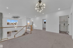 Unfurnished room featuring a chandelier, carpet flooring, and recessed lighting - 