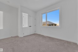 Unfurnished bedroom with light carpet and a closet - 