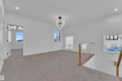 Carpeted spare room featuring a chandelier and recessed lighting - 
