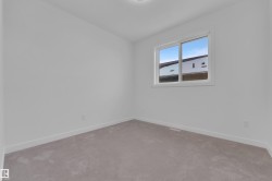 Carpeted empty room featuring baseboards - 