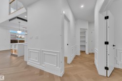 Corridor featuring recessed lighting, an upstairs landing, and a decorative wall - 