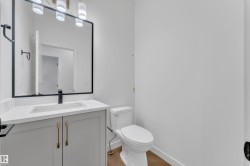 Bathroom with vanity and light wood-style floors - 