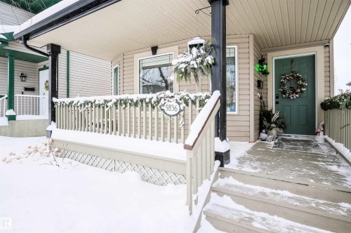 Snow covered property entrance with covered porch - 5836 204 Street, Edmonton, AB - Outdoor With Deck Patio Veranda