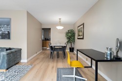 Dining space with light wood-style floors and baseboards - 