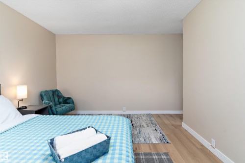 Bedroom featuring wood finished floors and a textured ceiling - 17107 86 Avenue Nw, Edmonton, AB - Indoor Photo Showing Bedroom