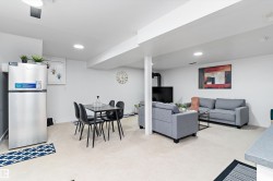 Living area with recessed lighting and light colored carpet - 