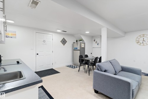 Living room with light colored carpet and recessed lighting - 17107 86 Avenue Nw, Edmonton, AB - Indoor