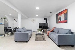 Living area featuring light carpet, recessed lighting, and a wood stove - 