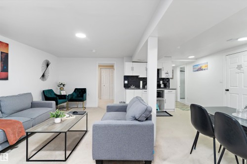 Living area with light colored carpet and recessed lighting - 17107 86 Avenue Nw, Edmonton, AB - Indoor Photo Showing Living Room