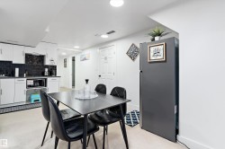 Dining space with recessed lighting and wet bar - 
