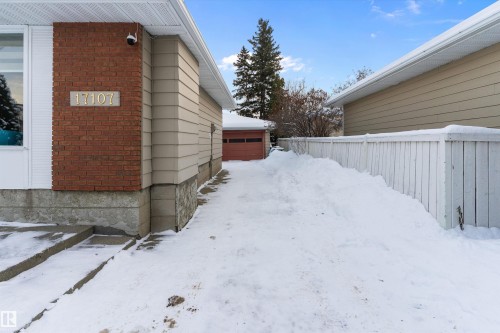 View of snow covered exterior featuring brick siding - 17107 86 Avenue Nw, Edmonton, AB - Outdoor With Exterior