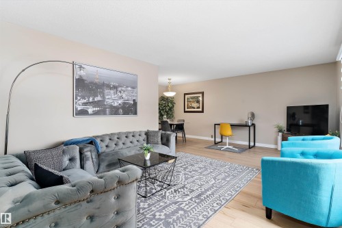 Living area featuring wood finished floors and baseboards - 17107 86 Avenue Nw, Edmonton, AB - Indoor Photo Showing Living Room