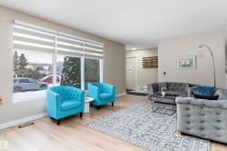 Living area with baseboards and light wood finished floors - 