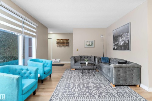 Living room featuring light wood finished floors and baseboards - 17107 86 Avenue Nw, Edmonton, AB - Indoor Photo Showing Living Room