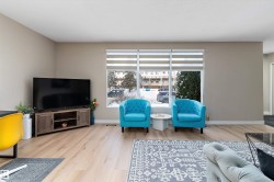 Living area featuring light wood-style flooring and baseboards - 