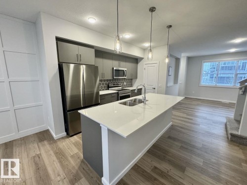 126 Stiles Bend, Leduc, AB - Indoor Photo Showing Kitchen With Double Sink With Upgraded Kitchen