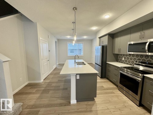 126 Stiles Bend, Leduc, AB - Indoor Photo Showing Kitchen With Double Sink