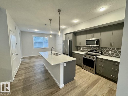 126 Stiles Bend, Leduc, AB - Indoor Photo Showing Kitchen With Double Sink With Upgraded Kitchen