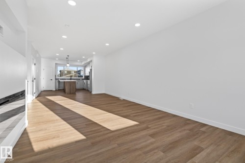Unfurnished living room with recessed lighting and dark wood finished floors - 206 Starling, Fort Saskatchewan, AB - Indoor Photo Showing Other Room