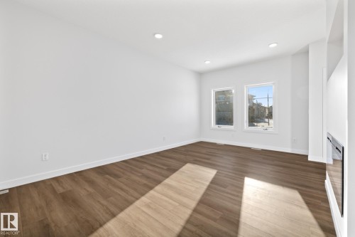 Unfurnished living room featuring wood finished floors and recessed lighting - 206 Starling, Fort Saskatchewan, AB - Indoor Photo Showing Other Room