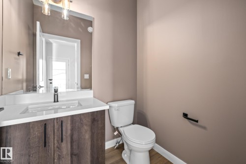 Bathroom with vanity and wood finished floors - 206 Starling, Fort Saskatchewan, AB - Indoor Photo Showing Bathroom
