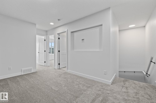 Empty room featuring carpet and recessed lighting - 206 Starling, Fort Saskatchewan, AB - Indoor Photo Showing Other Room