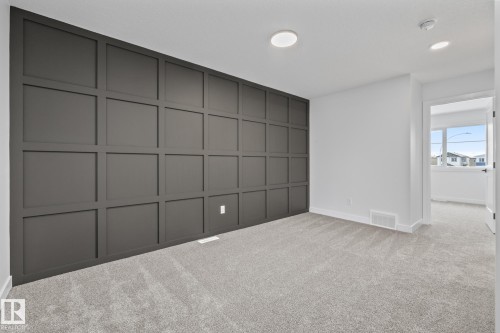 Unfurnished bedroom with a decorative wall, light colored carpet, and recessed lighting - 206 Starling, Fort Saskatchewan, AB - Indoor Photo Showing Other Room