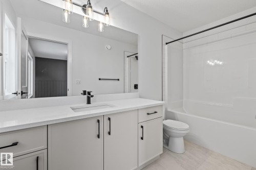 Full bathroom featuring vanity, tub / shower combination, and light tile patterned flooring - 206 Starling, Fort Saskatchewan, AB - Indoor Photo Showing Bathroom