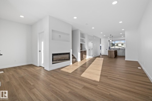 206 Starling, Fort Saskatchewan, AB - Indoor Photo Showing Other Room With Fireplace