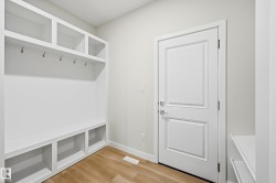 Mudroom featuring light wood finished floors and baseboards - 