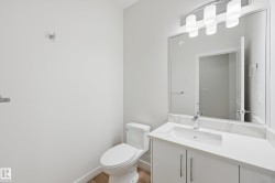 Bathroom with vanity and light wood-style floors - 