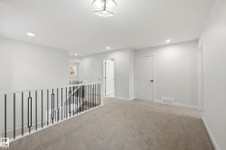 Corridor with carpet flooring, recessed lighting, and an upstairs landing - 