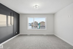 Empty room featuring a textured ceiling and light carpet - 