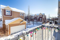 Snow covered back of property featuring a residential view - 