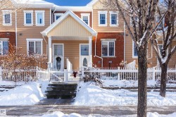 View of front of house with a porch and brick siding - 