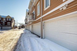 View of property exterior with a residential view and an attached garage - 