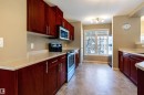 Kitchen with dark brown cabinets, appliances with stainless steel finishes, and light countertops - 1615 Towne Centre Boulevard, Edmonton, AB  - Indoor Photo Showing Kitchen 