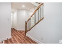 Stairs featuring wood finished floors and baseboards - 1703 152 Avenue, Edmonton, AB  - Indoor Photo Showing Other Room 