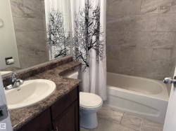Bathroom with vanity and shower / tub combo - 