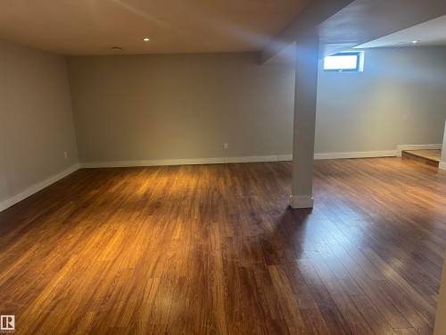 Staircase featuring wood finished floors and baseboards - 21 Lundy Park Road, Stony Plain, AB - Indoor Photo Showing Other Room