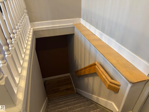 Stairs with baseboards and wood finished floors - 21 Lundy Park Road, Stony Plain, AB - Indoor Photo Showing Other Room
