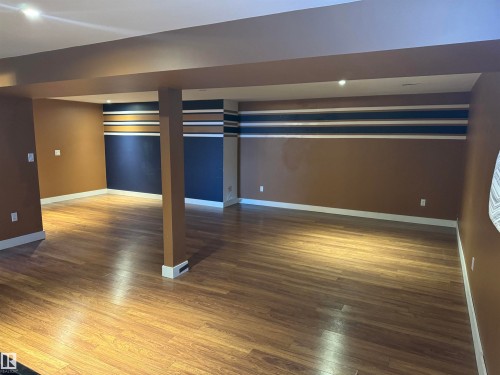 Finished basement with dark wood finished floors and recessed lighting - 21 Lundy Park Road, Stony Plain, AB - Indoor Photo Showing Other Room