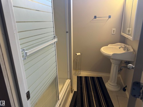 Full bath with light tile patterned floors and a shower stall - 21 Lundy Park Road, Stony Plain, AB - Indoor Photo Showing Bathroom