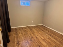 Spare room featuring wood finished floors and baseboards - 