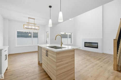 63 Silverstone Drive, Stony Plain, AB - Indoor Photo Showing Kitchen With Fireplace With Double Sink