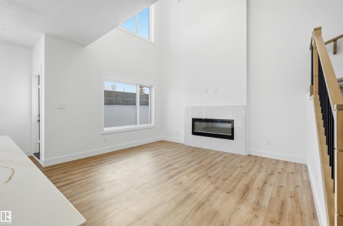 63 Silverstone Drive, Stony Plain, AB - Indoor Photo Showing Living Room With Fireplace