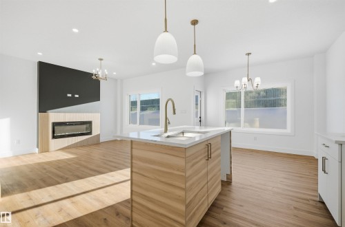 65 Silverstone Drive, Stony Plain, AB - Indoor Photo Showing Kitchen With Fireplace With Double Sink